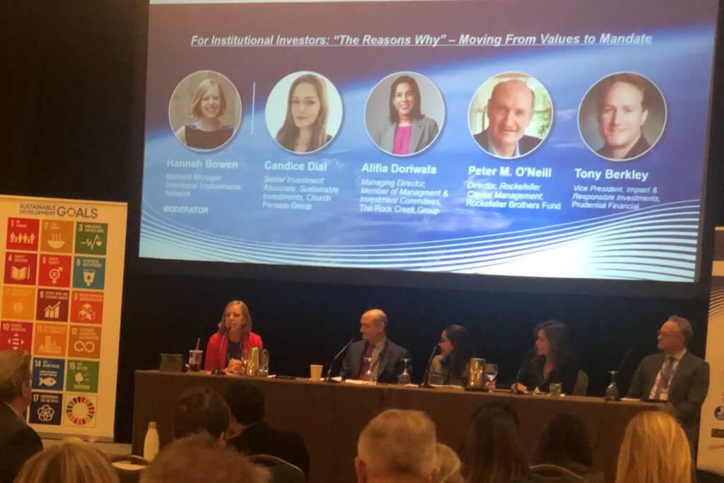 Photo of Hannah Bowen moderating a panel at a conference about sustainable investing