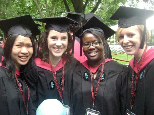 Photo of Hannah and three classmates in caps and gowns during graduation ceremonies